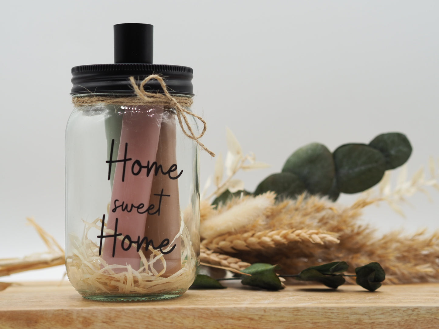 Beplottertes Stabkerzenglas mit dem Aufdruck „Home Sweet Home“ inklusive 3 Stabkerzen.